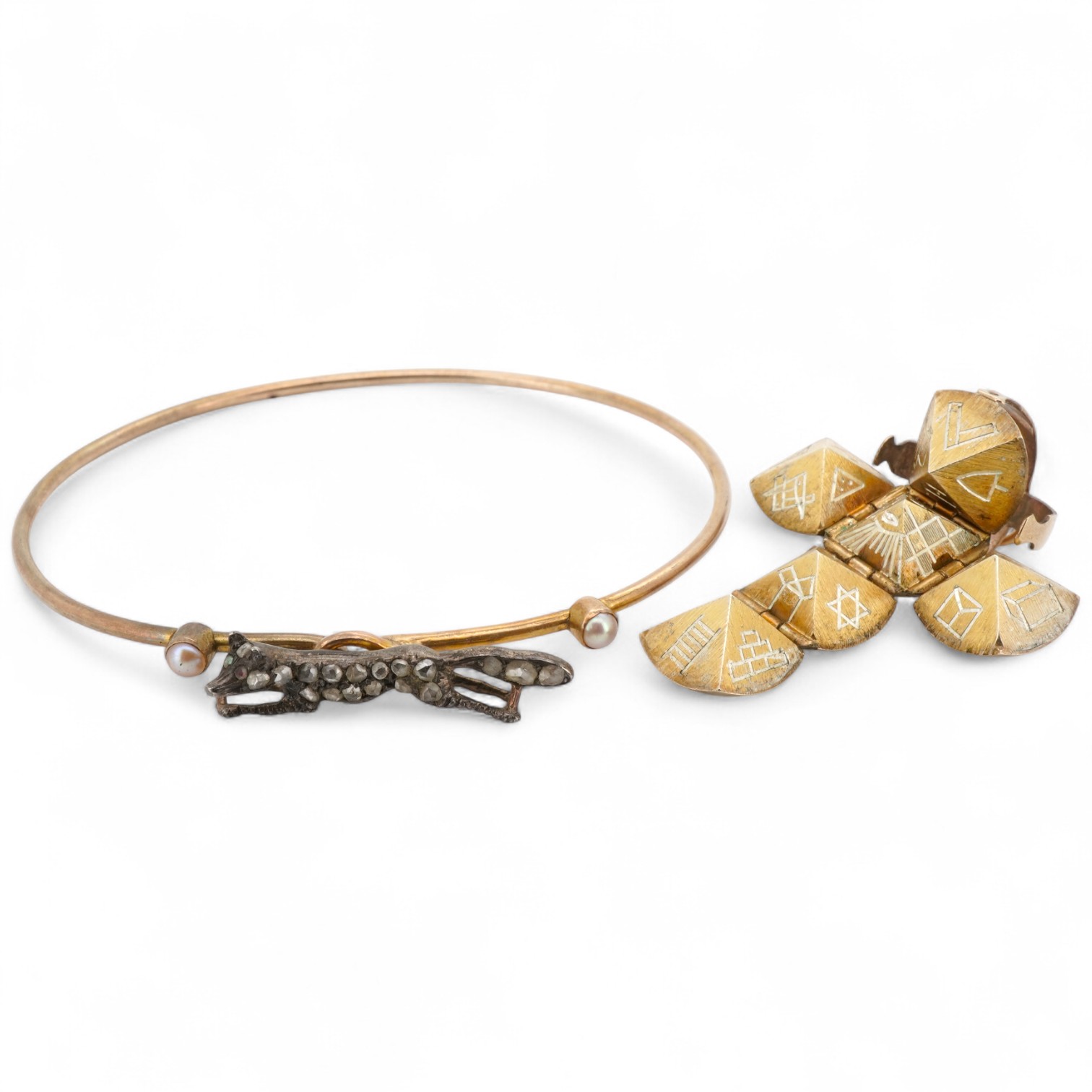 A Masonic ball pendant and a pearl and diamond bangle, early 20th century, the Masonic ball folding open to reveal a cross shape engraved with Masonic symbols, in gilt silver, length 2.2cm when closed, stamped Silver & G